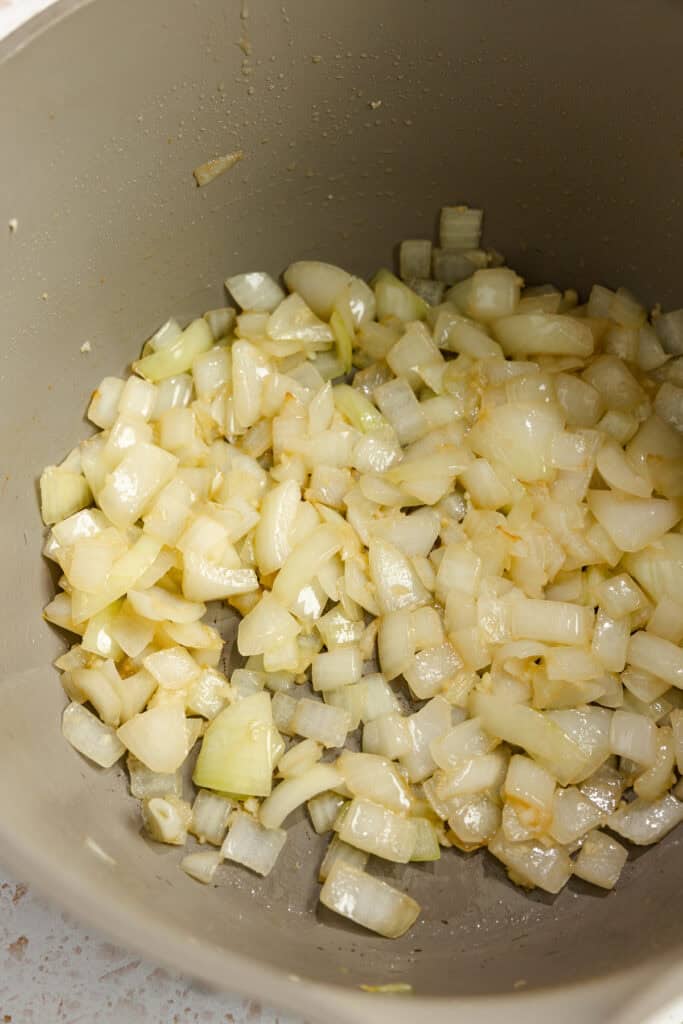 onions and garlic sautéing in a pot.