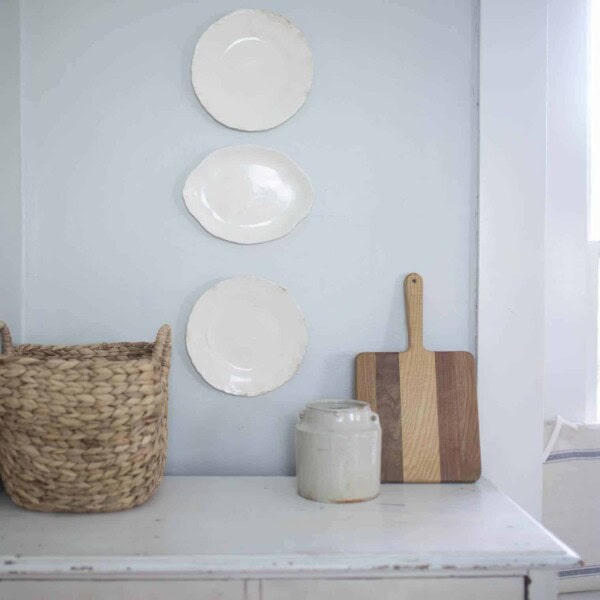 farmhouse plates hanging on a wall above a dresser