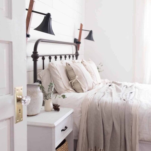 Tour our winter farmhouse bedroom with lots of natural elements like greenery and pine cones.