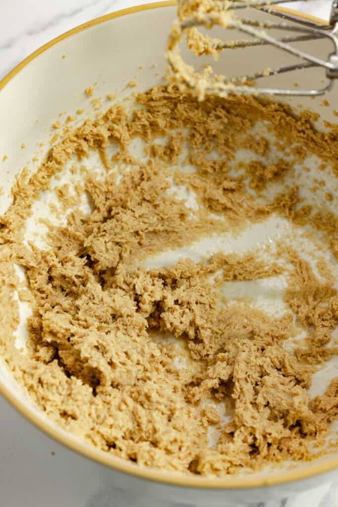 Butter and sugar creamed together in a bowl with a hand mixer.