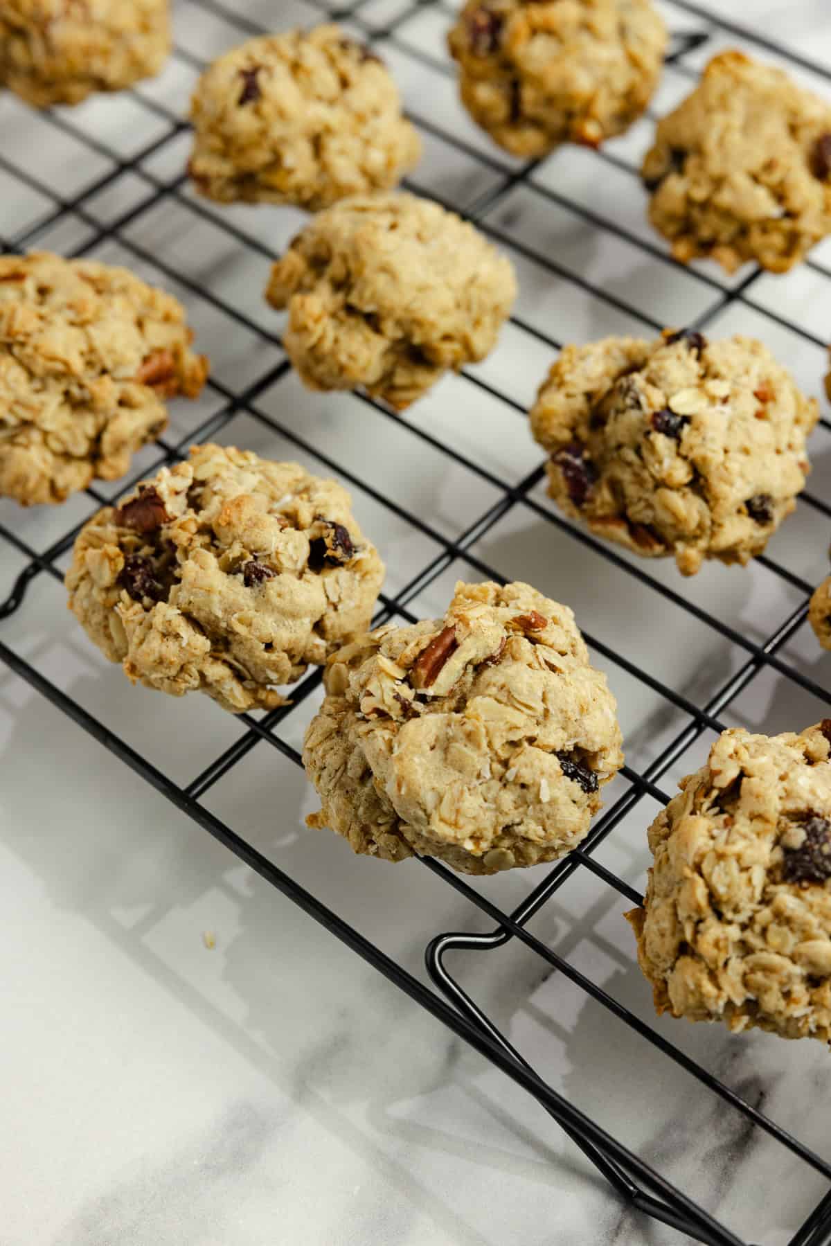 Granola cookies cooling on a wire rack.