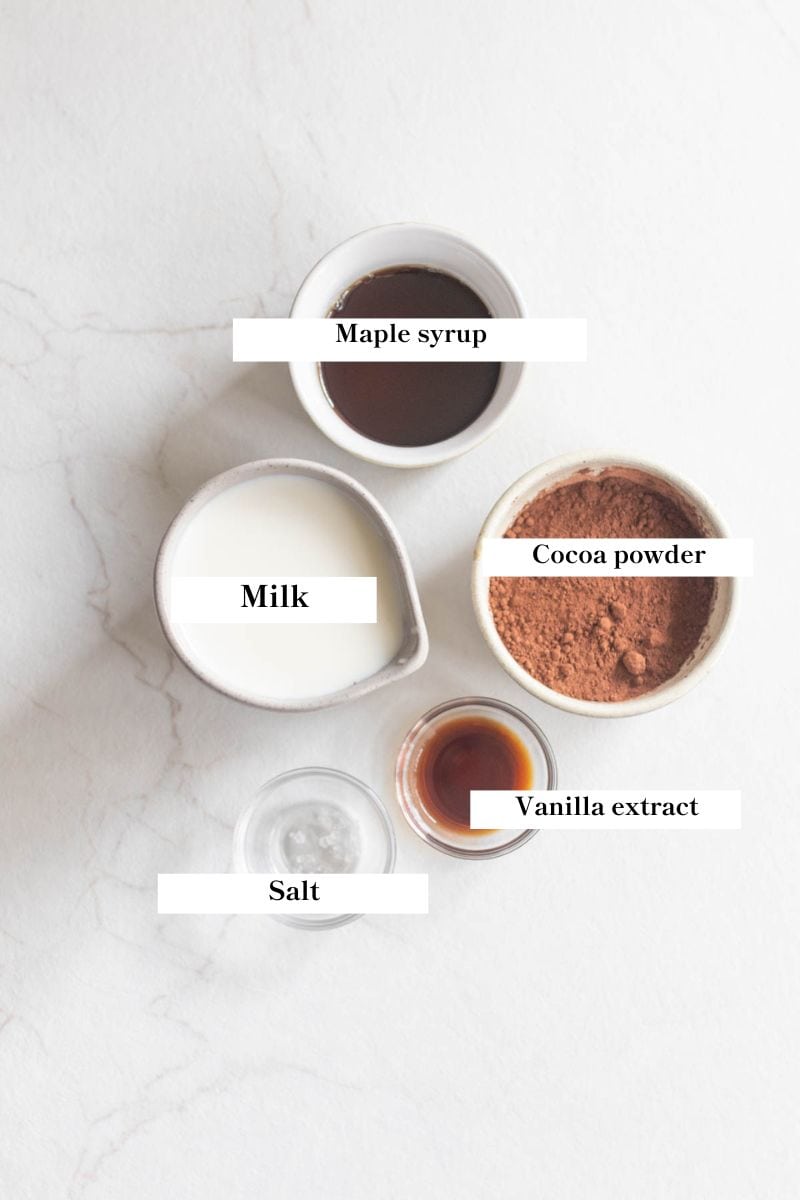 Healthy hot chocolate ingredients in white and clear bowls. 