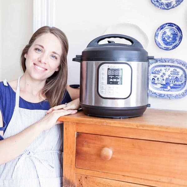 women standing next to large wood cabinet with a Instant Pot on top