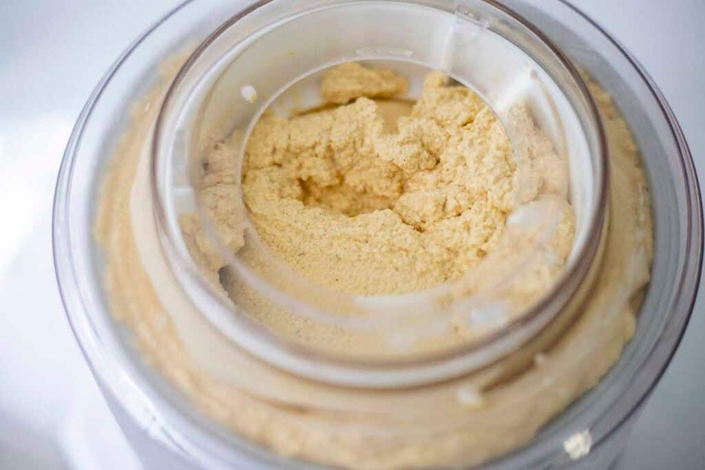 Pumpkin ice cream churning in an ice cream maker.