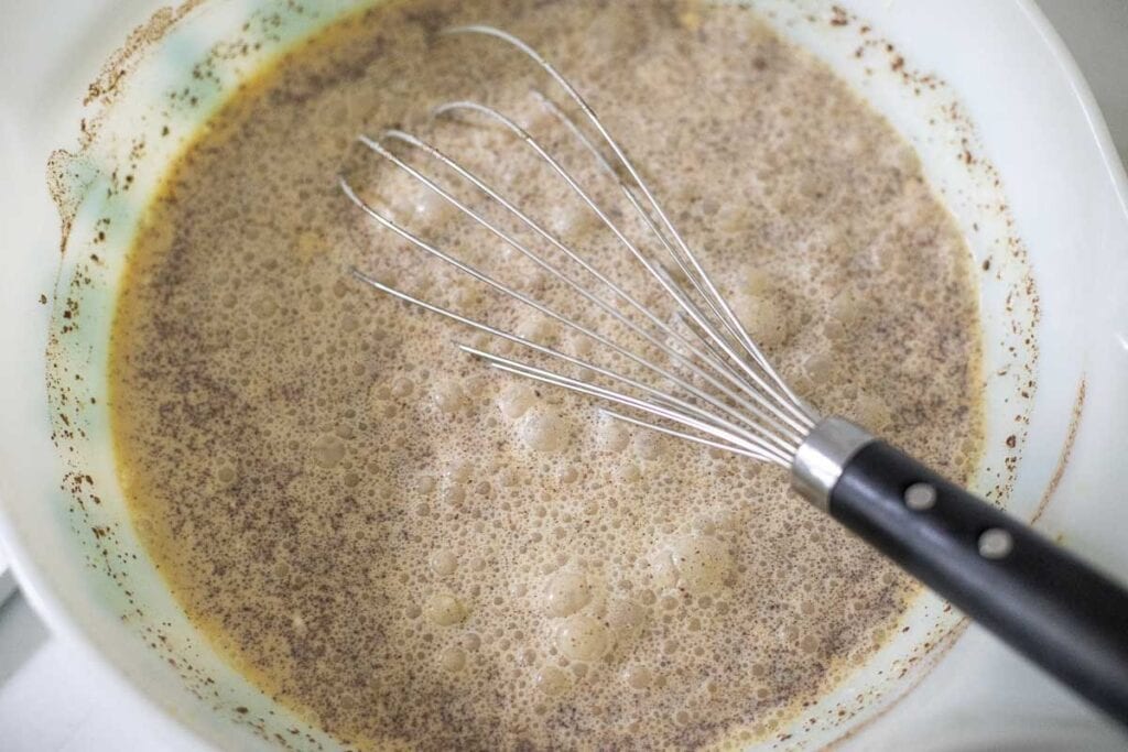 Pumpkin ice cream whisked together in a bowl.