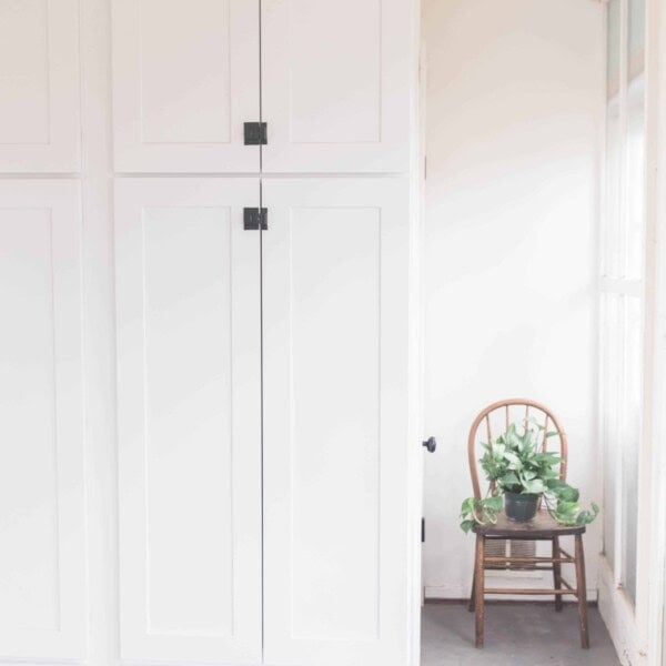 large white cabinets with black latches for farmhouse mud room organization