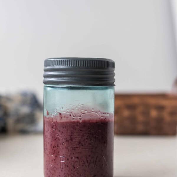 fermented balsamic blueberry vinaigrette in a glass jar with a metal lid