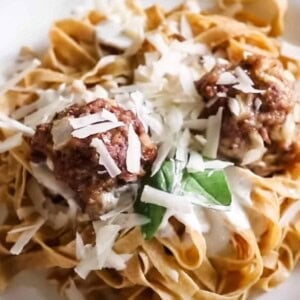 einkorn pasta with meatballs topped with cheese and basil