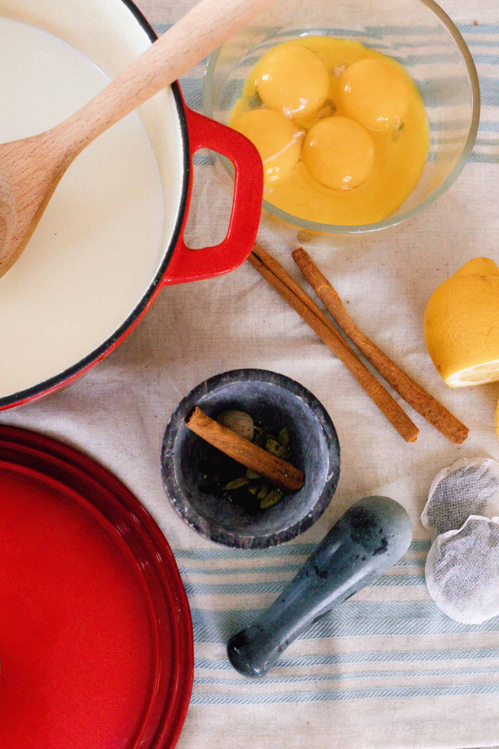 chai ice cream ingredients on a blue and white striped table cloth.