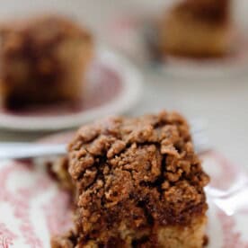 sourdough coffee cake with cinnamon crumble on a white and red vintage plates