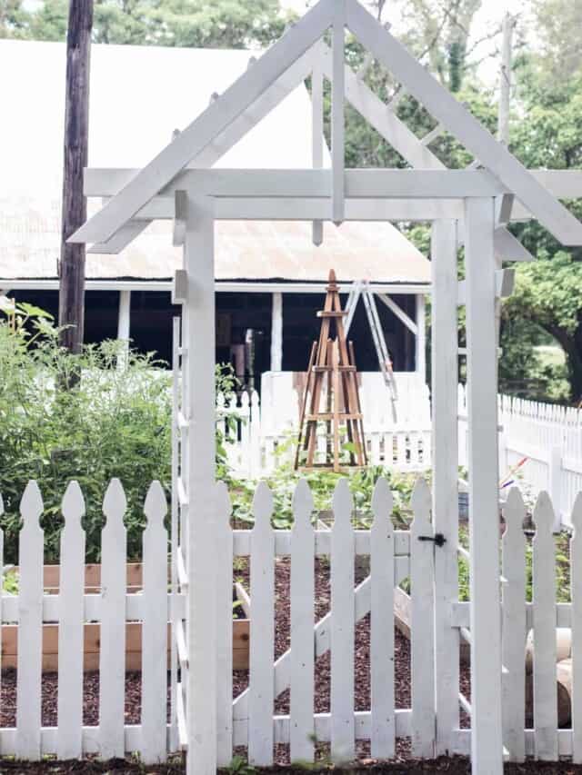 garden entrance with an arbor and a white picket fence - how to start a garden