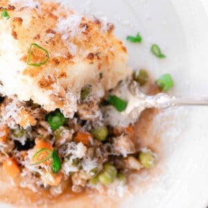 Shepards pie on a plate with an antique spoon