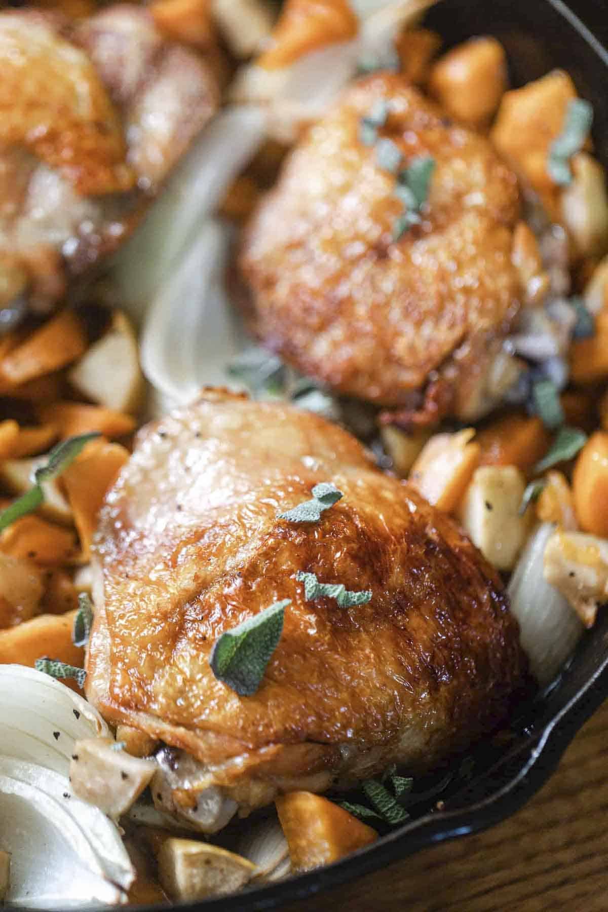 crispy maple roasted chicken with sweet potatoes and apples.