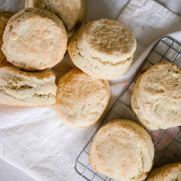 sourdough biscuits spread out on a linen towel and wire rack