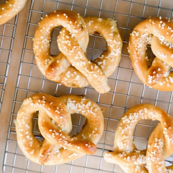 overhead photo of six sourdough pretzels on a wire cooling rack.