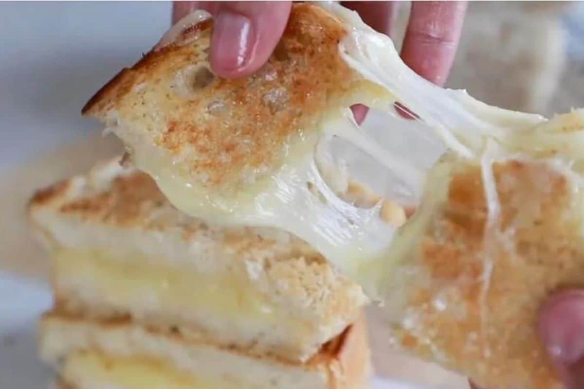 Sourdough grilled cheese being pulled a part.