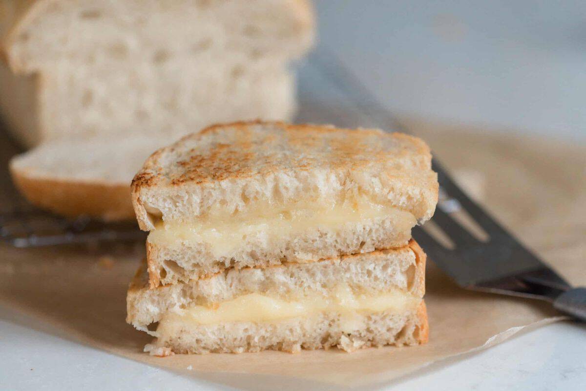 Sourdough grilled cheese cut in half.