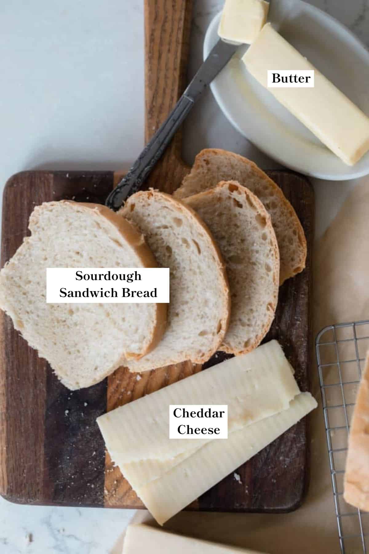 Sourdough grilled cheese ingredients, including butter, bread, and cheese. 