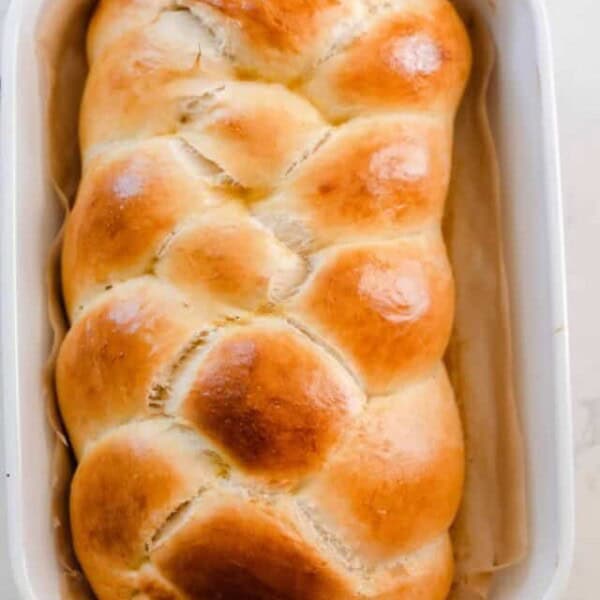 overhead photo of a loaf of fluffy and golden sourdough challah