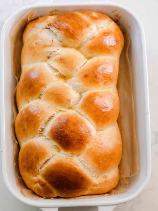 overhead photo of a loaf of fluffy and golden sourdough challah