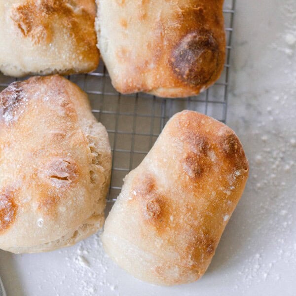 six sourdough ciabatta loaves on a wire rack