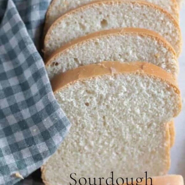 slices of sourdough buttermilk bread fanned out on a white and blue checked towel