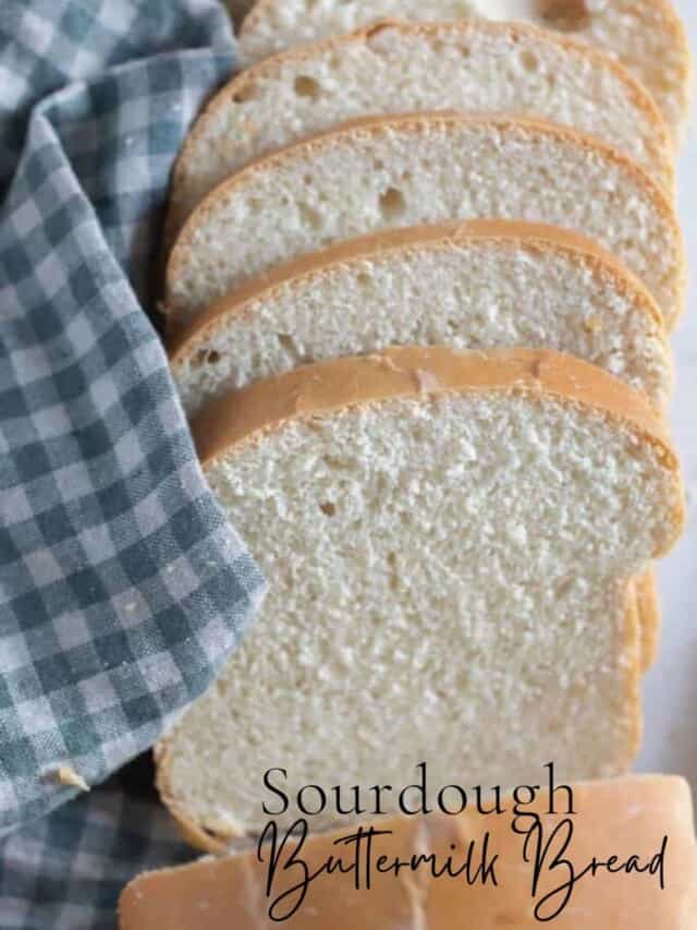 slices of sourdough buttermilk bread fanned out on a white and blue checked towel