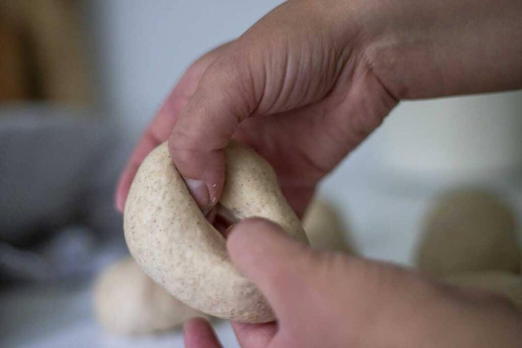 hands shaping bagels.