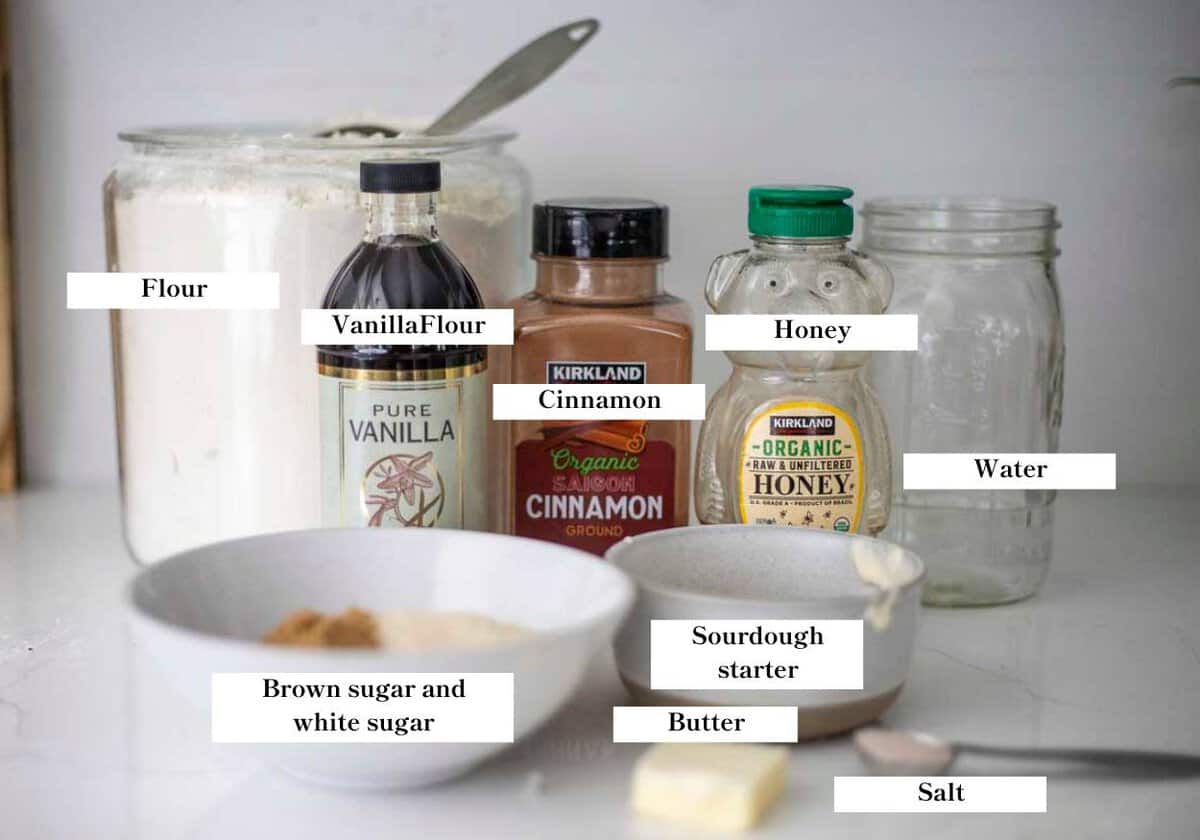 jars, containers, and bowls of ingredients on a white countertop.