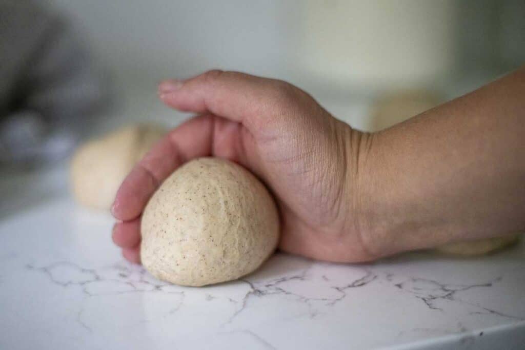 rolling bagel dough into balls.