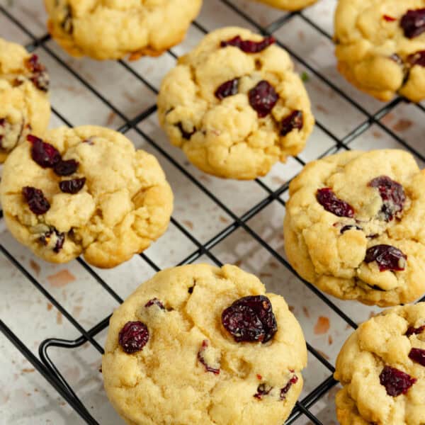 Cranberry orange cookies lined up on a cooling rack.