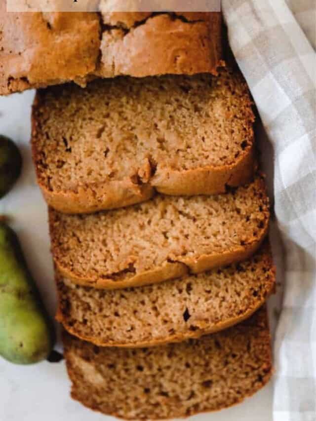 overhead photo of pawpaw bread sliced on a white and tan checked towel