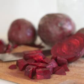 beets sliced on a wood cutting board.