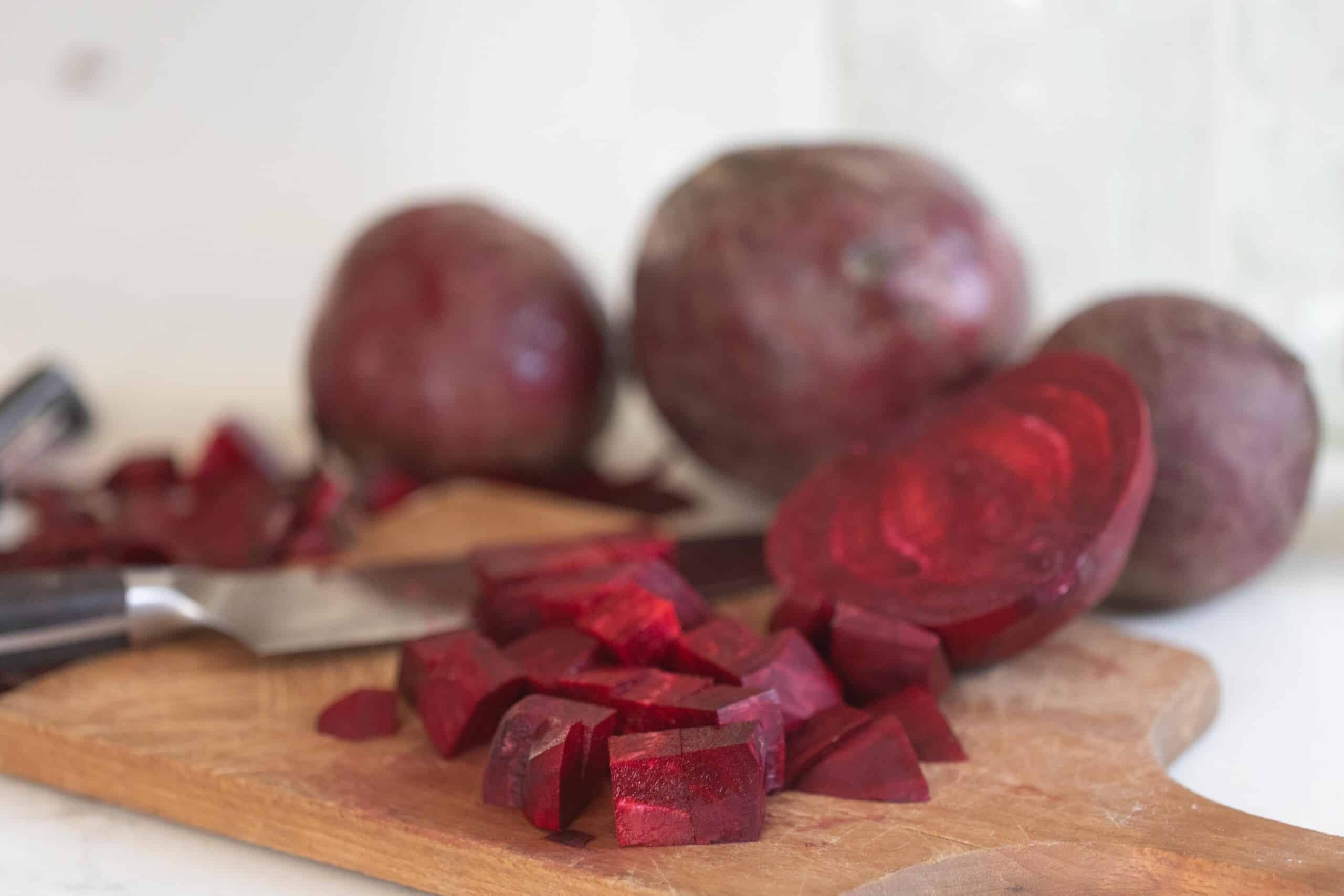 beets sliced on a wood cutting board.