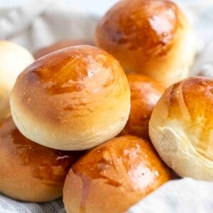 a close tip of sourdough discard rolls in a towel lined dish