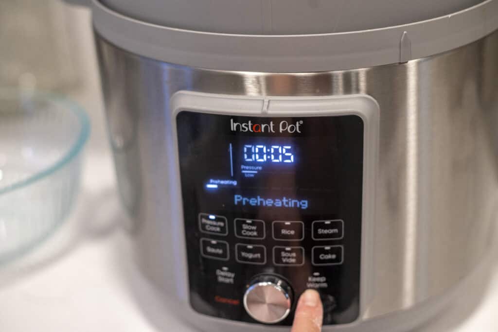 Setting the Instant Pot to high pressure for 5 minutes.