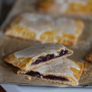 sourdough poptart cut in half and stacked on top of each other with other pop tarts in the background