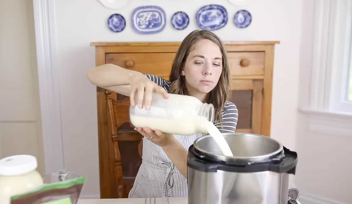 woman adding a half gallon of milk to the instant pot