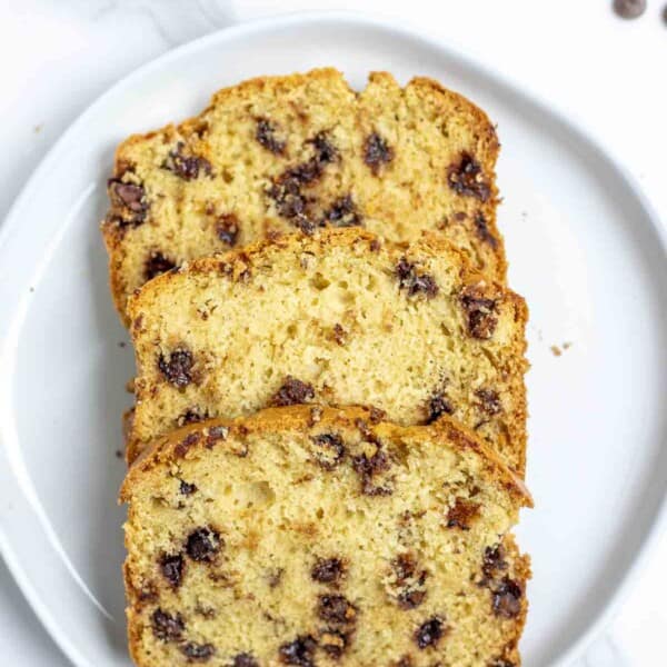 three slices of sourdough chocolate chip bread on a white plate.