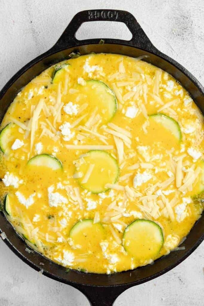 zucchini, with eggs mixture and cheese poured on top in a case iron skillet.