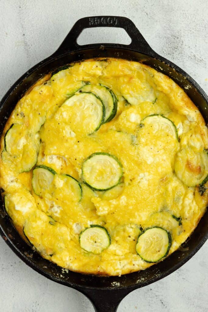 baked zucchini frittata in a cast iron skillet.