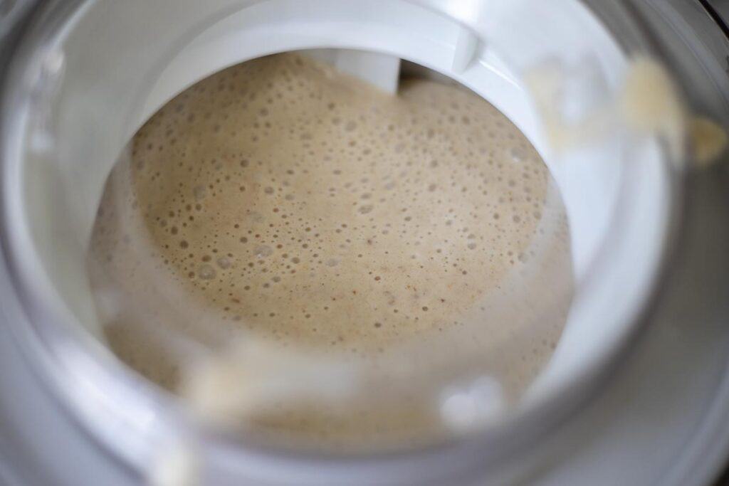 Date ice cream poured into an ice cream maker.