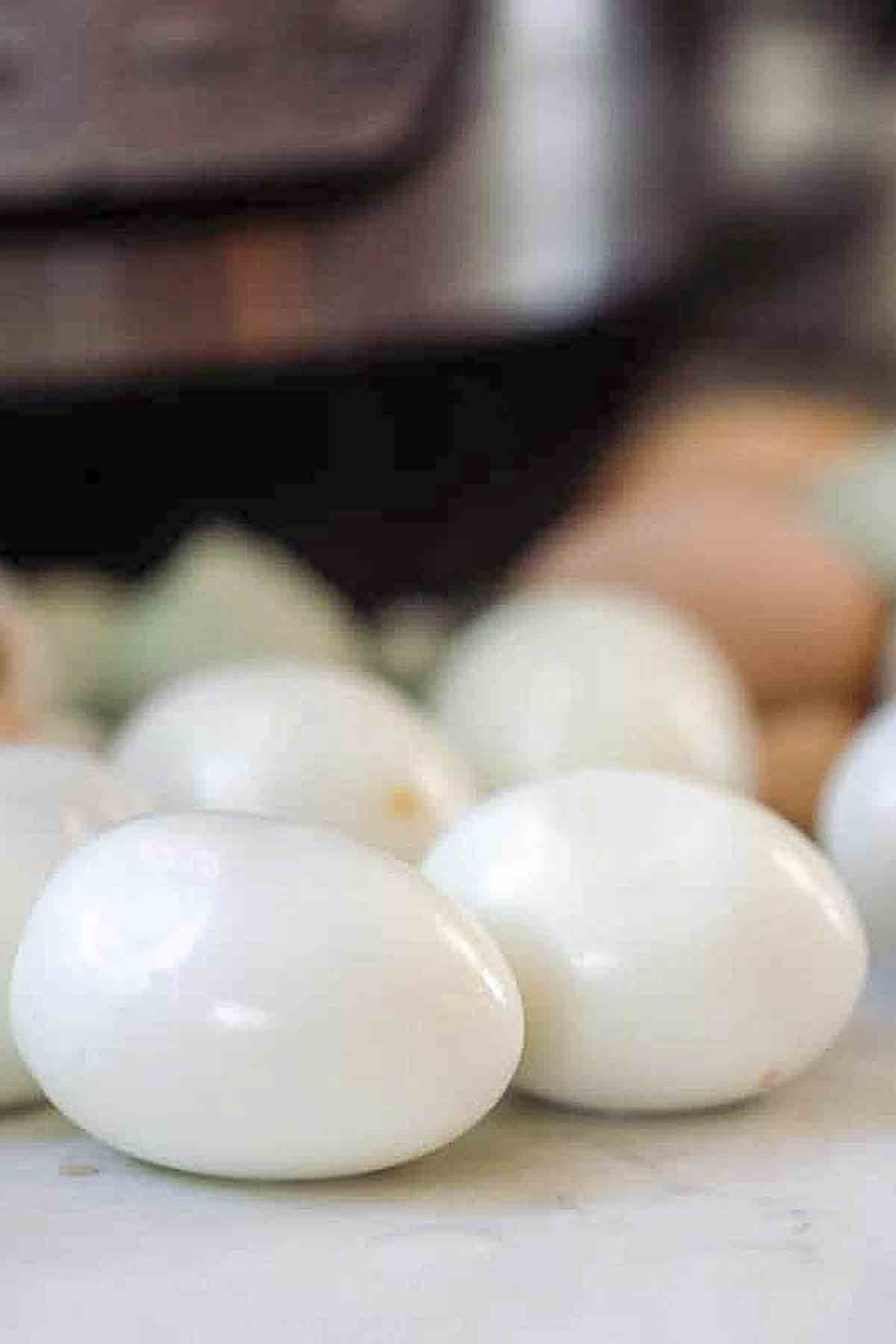 Hard-boiled eggs on a countertop with an Instant Pot in the background