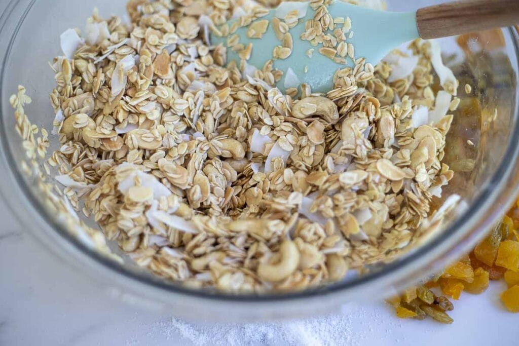 A large bowl of homemade granola mixed up and ready to bake. 