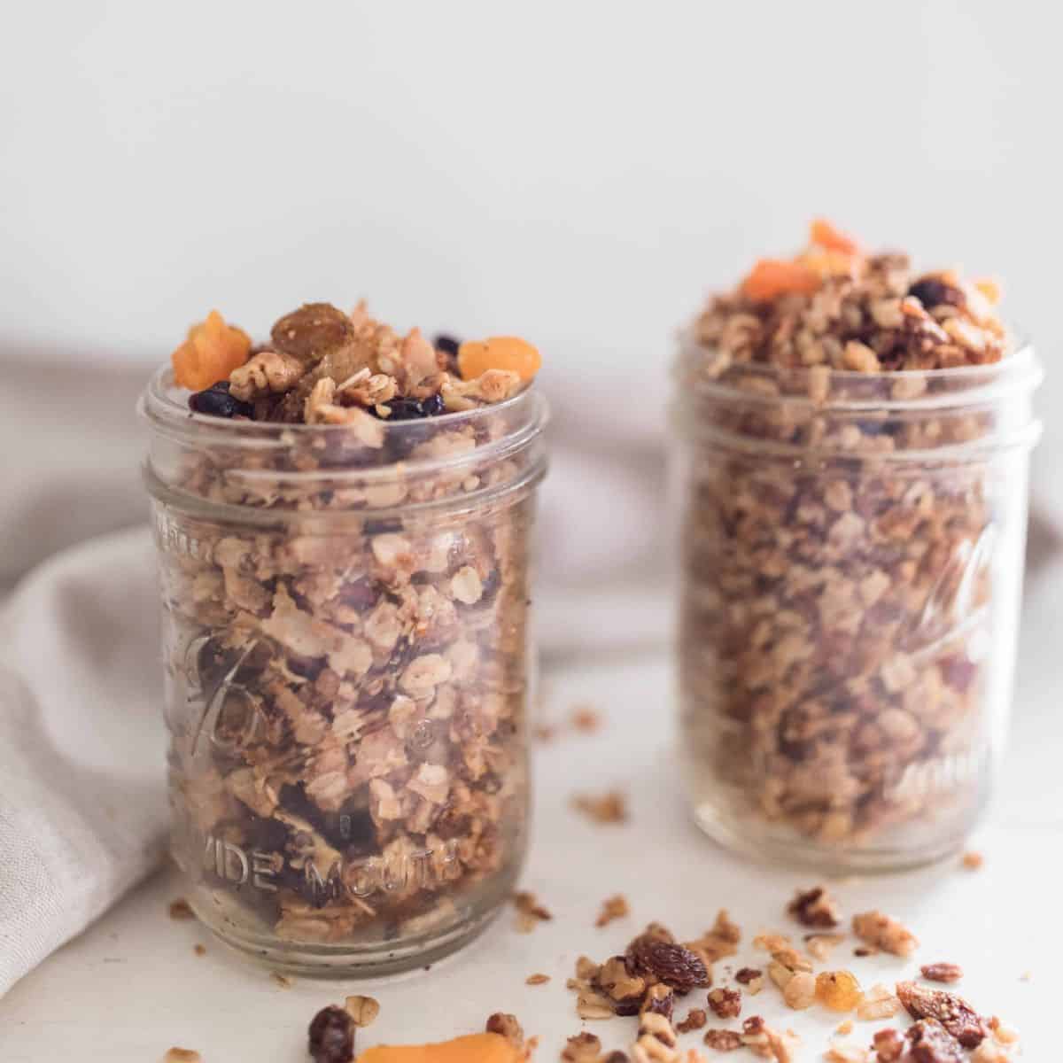 Two mason jars filled with homemade granola. 