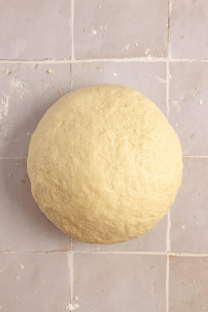 Ball of dough on a countertop.