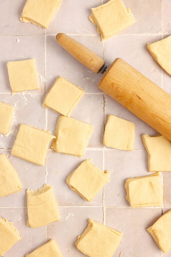 Dough cut into squares with a rolling pin.