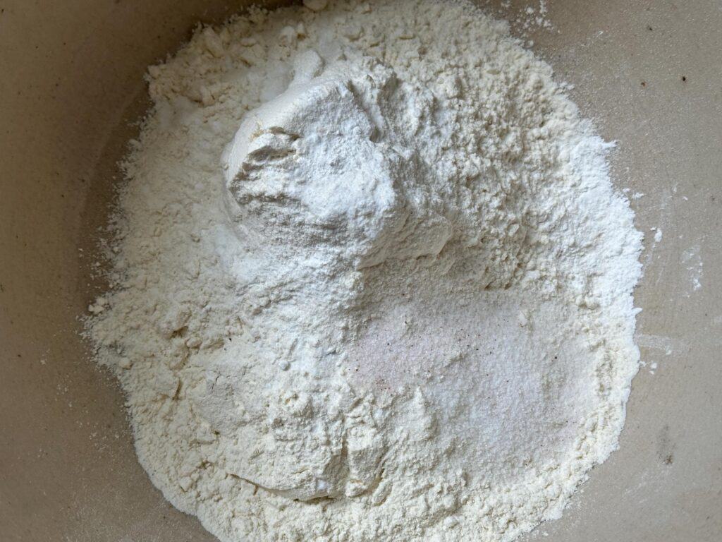 Flour, salt, baking soda mixed together in a bowl.