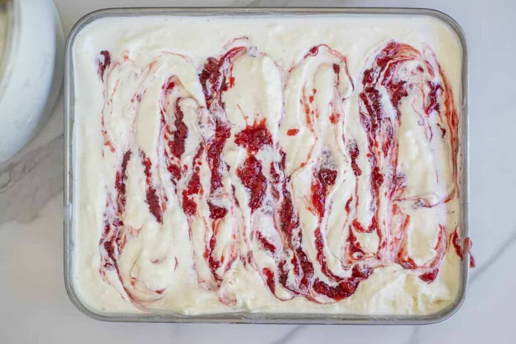 Strawberry jam swirled into cheesecake ice cream.