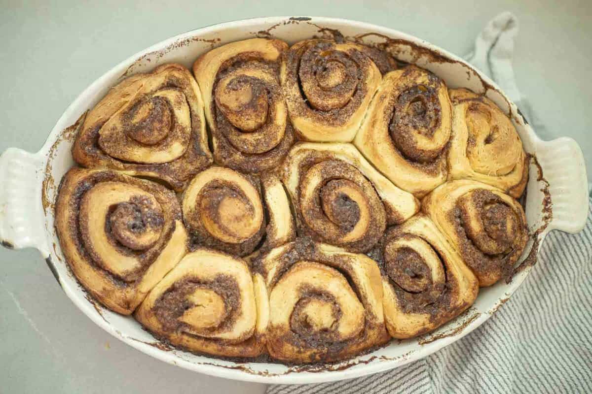 Baked brioche cinnamon rolls in a baking dish.